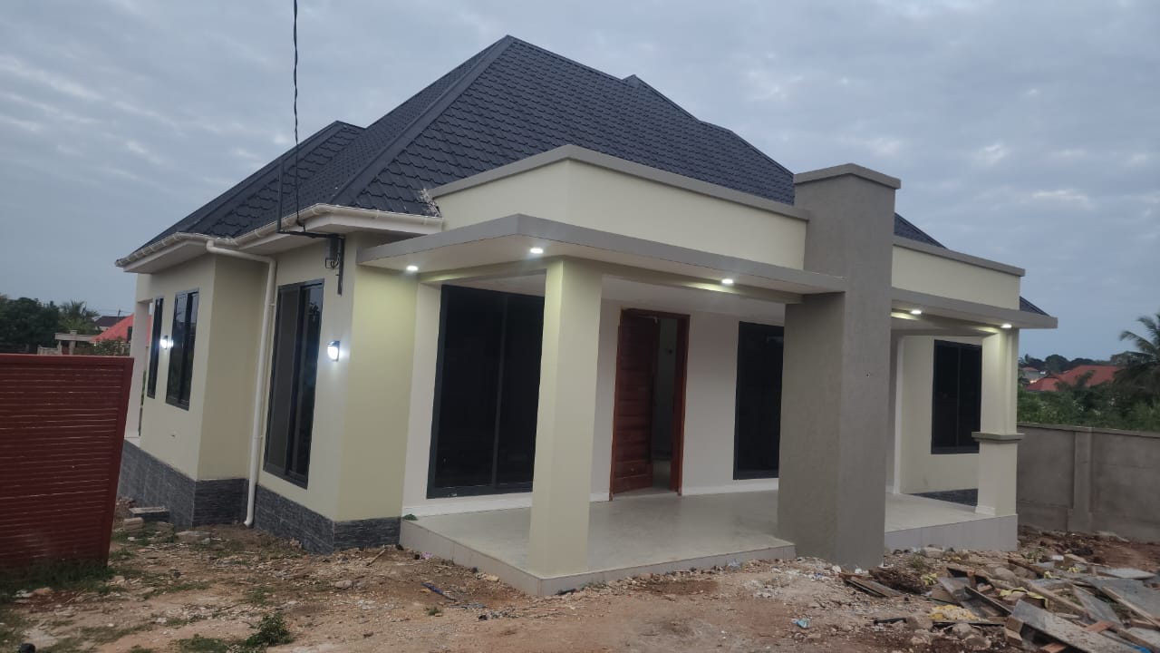 Front elevation with recessed lighting under evening sky