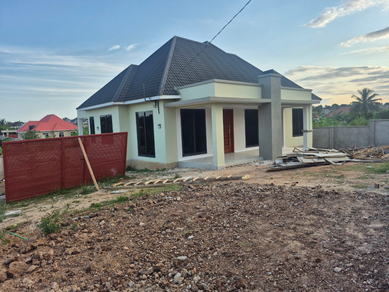 Completed residential home at dusk — Dar es Salaam
